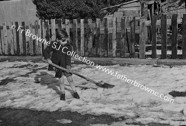 CHILD PLAYING WITH SHOVEL